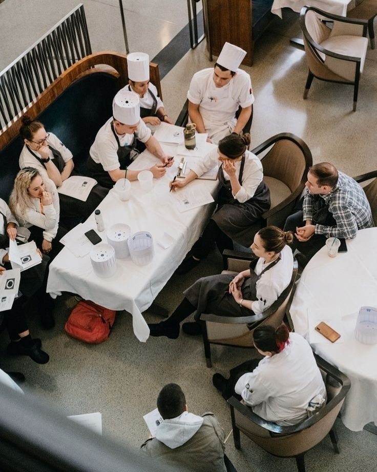 OUZO trainees serving guests in a restaurant setting